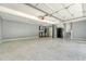 Spacious garage with epoxy flooring, gray walls, overhead lighting and storage cabinets at 1208 Wynnwood Ct, Mount Pleasant, SC 29466