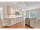 Beautiful kitchen with white cabinets, granite counters, stainless steel appliances and wood floors at 1208 Wynnwood Ct, Mount Pleasant, SC 29466