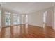 Expansive living area boasts hardwood floors, neutral paint, and glass doors to bring in natural light at 1208 Wynnwood Ct, Mount Pleasant, SC 29466