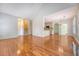 Open-concept living room with hardwood floors and open access to kitchen and stairway at 1208 Wynnwood Ct, Mount Pleasant, SC 29466