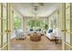 Bright sunroom with tile floors, white trim, and comfortable seating at 1208 Wynnwood Ct, Mount Pleasant, SC 29466
