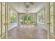 Bright sunroom featuring tile floors, white trim, and French doors leading to the outdoor space at 1208 Wynnwood Ct, Mount Pleasant, SC 29466