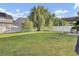 Spacious backyard with green lawn, fence, mature tree, and other greenery at 123 Blackwater Way, Moncks Corner, SC 29461