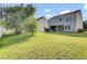 Well-maintained backyard with green grass, landscaping, and a patio area at 123 Blackwater Way, Moncks Corner, SC 29461