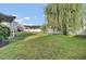 Spacious backyard with green lawn, fence, mature tree, and other greenery at 123 Blackwater Way, Moncks Corner, SC 29461
