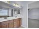 Bathroom featuring a double sink vanity with wood cabinets and access to bedroom and bathroom at 123 Blackwater Way, Moncks Corner, SC 29461