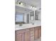 Bathroom featuring a double sink vanity with wood cabinets and large mirrors at 123 Blackwater Way, Moncks Corner, SC 29461