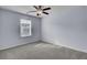 Carpeted bedroom features a ceiling fan and a window for natural light at 123 Blackwater Way, Moncks Corner, SC 29461