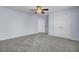 Spacious carpeted bedroom with fan, closet, and doorway, ensuring comfort and convenience at 123 Blackwater Way, Moncks Corner, SC 29461