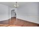 Bright and airy living room showcasing hardwood floors, wainscoting, and a glimpse of the staircase at 123 Blackwater Way, Moncks Corner, SC 29461