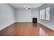 Spacious living room featuring hardwood floors, a cozy fireplace, and large windows that provide ample natural light at 123 Blackwater Way, Moncks Corner, SC 29461