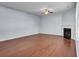 Bright living room with hardwood floors, ceiling fan, fireplace, and large windows for natural light at 123 Blackwater Way, Moncks Corner, SC 29461