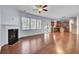 Open-concept living room with fireplace, hardwood floors, and natural light at 123 Blackwater Way, Moncks Corner, SC 29461