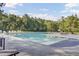 Community pool featuring pristine water surrounded by green trees and lounge chairs at 123 Blackwater Way, Moncks Corner, SC 29461