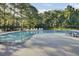 Sparkling community swimming pool with lounge chairs and lush landscaping at 123 Blackwater Way, Moncks Corner, SC 29461