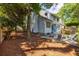 Spacious backyard with a fire pit, seating area, and mature trees at 1274 Hampshire Rd, Charleston, SC 29412