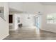 Open-concept living area with vaulted ceilings, wood floors, fireplace and bar with seating at 1274 Hampshire Rd, Charleston, SC 29412