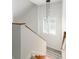 Staircase with wooden handrail leading to the upper level with lots of natural light at 1274 Hampshire Rd, Charleston, SC 29412