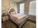 Comfortable bedroom with patterned bedding, side tables, soft lighting, and carpet at 136 Caleb Ct, Ladson, SC 29456