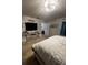 Spacious bedroom with a bed, TV, bedside table, closet entrance, and carpet at 136 Caleb Ct, Ladson, SC 29456