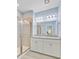Bathroom with a dual sink vanity, granite countertops, and glass-enclosed shower at 136 Rowans Creek Dr, Charleston, SC 29492