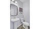 Powder room boasts stylish pedestal sink, wood-look floors and modern framed mirror at 136 Rowans Creek Dr, Charleston, SC 29492