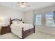 Comfortable bedroom with a ceiling fan, soft carpet, and natural light from two windows at 136 Rowans Creek Dr, Charleston, SC 29492