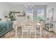Bright dining room with chandelier, white chairs, wood table, and colorful rug at 136 Rowans Creek Dr, Charleston, SC 29492