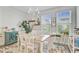 The cozy dining room has decor shelves, colorful rug, hardwood floors, and lots of natural light at 136 Rowans Creek Dr, Charleston, SC 29492