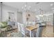 The bright dining room has a modern chandelier, colorful rug, and connects to the open kitchen at 136 Rowans Creek Dr, Charleston, SC 29492