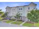 Street view showcasing modern townhomes with well-maintained landscaping and inviting walkways at 136 Rowans Creek Dr, Charleston, SC 29492