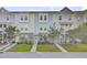 Charming townhome showcasing a well-maintained lawn, brick facade, and inviting curb appeal at 136 Rowans Creek Dr, Charleston, SC 29492