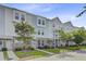 Street view of townhomes with brick and siding exteriors, complemented by landscaped front yards and sidewalks at 136 Rowans Creek Dr, Charleston, SC 29492