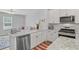 The bright kitchen features stainless appliances and stone countertops and connects to the living room at 136 Rowans Creek Dr, Charleston, SC 29492