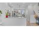 Open-concept kitchen with white cabinets, granite countertops, and a view into the dining area at 136 Rowans Creek Dr, Charleston, SC 29492