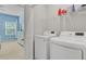 Convenient laundry room with modern washer and dryer units and shelving at 136 Rowans Creek Dr, Charleston, SC 29492