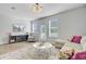Comfortable living room features a decorative chandelier, large windows, hardwood floors and lots of natural light at 136 Rowans Creek Dr, Charleston, SC 29492