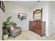Cozy sitting area features a grey tufted chair, dresser with mirror and mounted television at 136 Rowans Creek Dr, Charleston, SC 29492