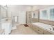 Bathroom features a walk-in shower, soaking tub, double sink vanity, and tile floors at 1407 Wando View St, Daniel Island, SC 29492
