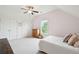 Well-lit bedroom has neutral colors, ceiling fan and an external window at 1407 Wando View St, Daniel Island, SC 29492