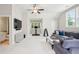Large bonus room has neutral carpeting, a ceiling fan, ample windows, and plenty of space to relax at 1407 Wando View St, Daniel Island, SC 29492