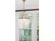 Elegant glass bead chandelier illuminating the dining area with natural light from nearby windows at 1407 Wando View St, Daniel Island, SC 29492
