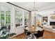 Bright dining area featuring a view to the sunroom and an adjacent living area with fireplace at 1407 Wando View St, Daniel Island, SC 29492