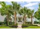 Charming two-story home with a welcoming front porch and beautifully landscaped yard with lush palm trees at 1407 Wando View St, Daniel Island, SC 29492