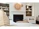 Elegant fireplace with decorative baskets, built-in shelves and white mantle at 1407 Wando View St, Daniel Island, SC 29492