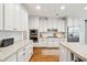 Stylish kitchen featuring white cabinetry, stainless steel appliances and tile backsplash at 1407 Wando View St, Daniel Island, SC 29492