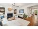 Bright and airy living room with a cozy fireplace, built-in shelves, and stylish decor at 1407 Wando View St, Daniel Island, SC 29492