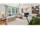 Bright living room featuring a fireplace, built-in shelving, and large windows for natural light at 1407 Wando View St, Daniel Island, SC 29492