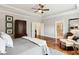Comfortable main bedroom features hardwood floors, ceiling fan, en-suite bathroom access and a walk-in closet at 1407 Wando View St, Daniel Island, SC 29492