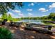 Picturesque lakeside view with picnic tables, grill, lush greenery, and clear blue skies creating a serene outdoor setting at 1407 Wando View St, Daniel Island, SC 29492